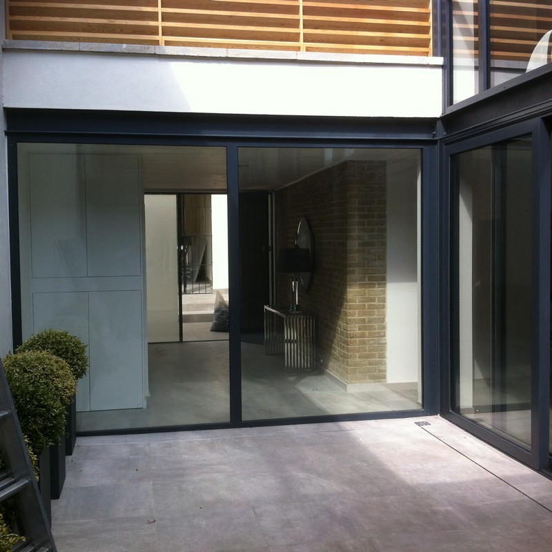 Floor-to-ceiling sliding doors opening to courtyard in Abbey Wood