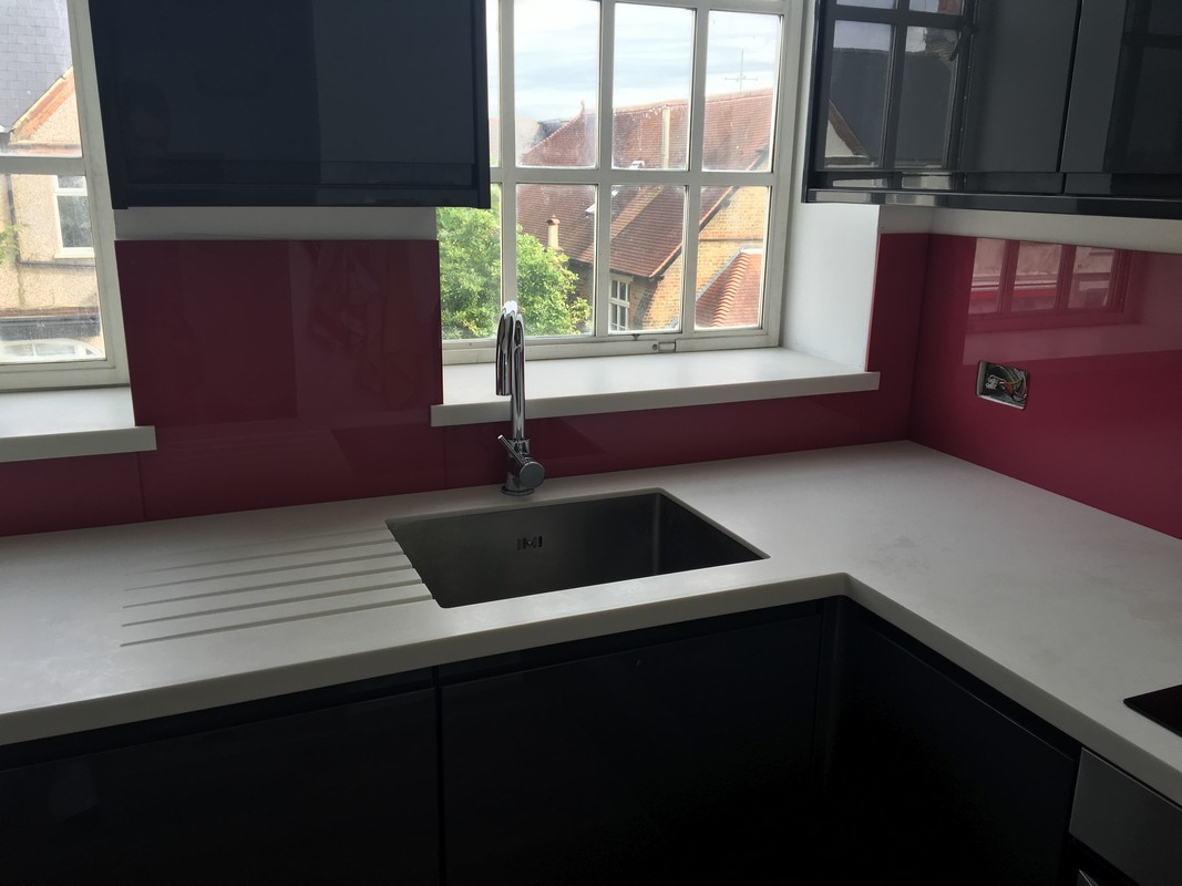Deep plum coloured glass splashback in modern Abbey Wood kitchen